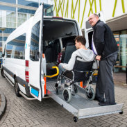 driver helping man in a wheelchair